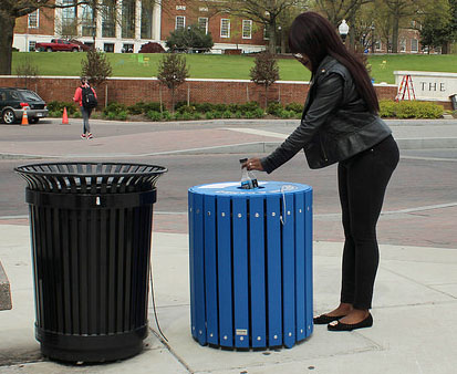 Blue recycling bins will stand next to streetside trash cans in 20 locations near four anchor institutions.